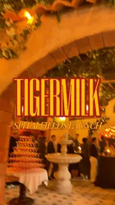 A fast-paced, engaging vlog-style video showcasing the launch of the new Tiger Milk branch in Spitalfields. The video highlights the venue's stylish Latin American-inspired decor, including a large central bar and a floor-to-ceiling bookcase, while featuring various food items like tacos, churros, and desserts, alongside cocktails. The creator captures the lively, social atmosphere of the launch event.