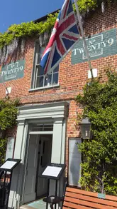 A montage-style video showcasing the interior and exterior of No. Twenty9 in Burnham Market. The video highlights the restaurant's decor, outdoor courtyard, menu, and a meal of fish and chips.