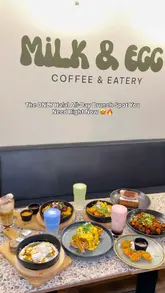 A short, fast-paced montage showcasing various brunch dishes, desserts, and drinks at a cafe called Milk & Egg. The video features close-up shots of food being prepared and served, highlighting the aesthetic presentation of the items.