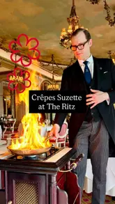 A high-quality, stable video showcasing the tableside preparation of Crêpes Suzette at The Ritz London. The clip focuses on the waiter's technique, the flambé process, and the final plating, set against the opulent backdrop of the restaurant's dining room.