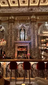 A short, engaging video tour of Apollo's Muse, a hidden bar located within the Bacchanalia restaurant in London. The video highlights the dramatic, Greek mythology-inspired interior design, the live DJ, and the cocktail experience.