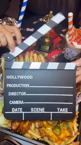 A food review video showcasing a variety of burgers, loaded fries, wings, and milkshakes at Hollywood Burgers & Shakes in Stretford. The video features close-up shots of the food items and a brief tour of the venue's interior.