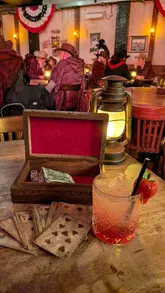 The video provides a glimpse into the Moonshine Saloon, an immersive, speakeasy-style bar experience. It features shots of the themed interior, staff in costume, and the cocktails served, highlighting the interactive nature of the venue.
