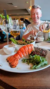A promotional video for Browns Brasserie & Bar in Glasgow, showcasing their new Spring/Summer menu. The video features close-ups of dishes like a seafood sharing platter, lobster surf and turf, and steak, alongside shots of the restaurant's interior and the diners enjoying their meal.