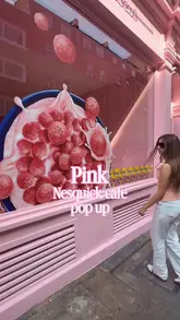 A short, handheld vlog-style video showcasing a pink-themed Nesquik cereal pop-up cafe in Covent Garden. The video features the exterior, the interior decor, the menu, and the experience of preparing a bowl of strawberry-flavored cereal.