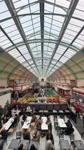 A fast-paced montage showcasing the Grainger Market in Newcastle, highlighting various food and drink vendors, live music, and the overall lively atmosphere on a Saturday night.