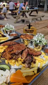 A vlog-style video showcasing a visit to a farm venue to try a new Texas BBQ platter. The video features shots of the food preparation, the final platter, the creator eating, the venue's outdoor seating area, and the farm's cows, set to music with text overlays.