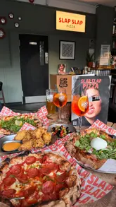 A promotional reel for Slap Slap Pizza, located inside Webrew in Kingston, showcasing their experimental pizza menu, fried chicken wings, and riverside location.