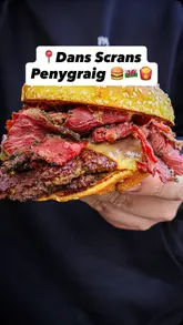 A food review of a food truck called 'Dans Scrans' in Penygraig, Wales, featuring a variety of indulgent items like a pastrami burger, a 'scran bowl' with smash burger and chicken, chorizo fries, sweet and sour chicken balls, and honey potato tots.
