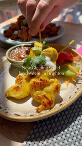 A promotional reel showcasing the new lunch tapas menu at Giggling Squid, featuring various set options, the restaurant's exterior, and the dining experience.
