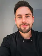 A high-quality, well-lit portrait of a chef, likely taken at a food festival. The image is clear, professional, and focuses on the individual, conveying a sense of expertise and approachability.