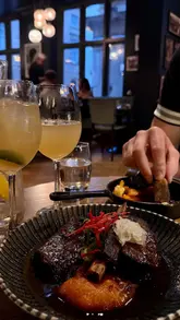 A montage video showcasing a visit to El Gato Negro Tapas, featuring shots of the exterior, menu, drinks, and a variety of Spanish tapas dishes.