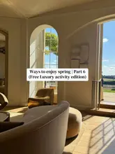 A beautifully composed, high-quality interior shot of a luxury venue, capturing the bright, airy atmosphere and the connection between the elegant indoor space and the countryside view outside.