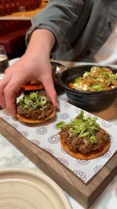 A montage video showcasing a variety of small plates and the interior of a restaurant called Bacchus, highlighting the food presentation and the atmosphere.