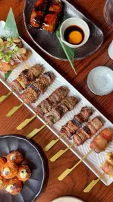 A high-quality promotional video for Sticks'n'Sushi in Manchester, focusing on their Japanese menu, specifically the interactive temaki set and various skewers. The video uses clean, well-lit shots to highlight the presentation of the food and the modern interior design.