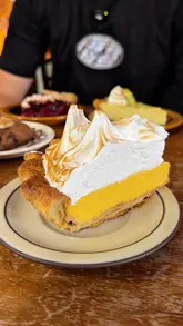 A creator visits 'Oh My Pie,' a new American pie spot located inside Radical Roasters coffee shop in Bristol. The video features a tour of the venue, a look at the pie selection, a taste test of the key lime, cherry, and passion fruit meringue pies, and a brief look at the coffee roasting process.
