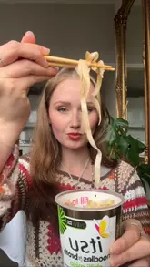 A sponsored video demonstrating how to upgrade an instant Itsu noodle pot with additional toppings like a jammy egg, mushrooms, and spring onions.