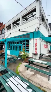 A promotional video for 'Picante or Don't' in Liverpool, showcasing the venue's dual atmosphere. The video features close-up shots of Mexican-inspired dishes like tacos, corn ribs, and buffalo wings during the day, followed by a transition to the evening setting with cocktails and a lively crowd.