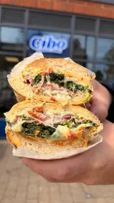 A review of Cibo Italian Subs, showcasing the preparation of their signature sandwiches like the 'Yardman' and 'Big Paulie', featuring behind-the-scenes kitchen footage and taste tests.