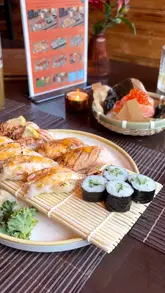 A promotional reel for a Japanese pop-up kitchen, Kasasagi, featuring close-up shots of various sushi dishes including aburi sushi and onigiri, set within a bar venue.