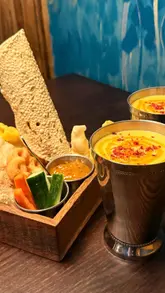 Here are a few options for your alt text, depending on the specific focus of the image:

**Option 1 (Focus on the meal/table):**
"A delicious spread of Indian curries, small plates, and sides served at Dhamroo restaurant in Oxford."

**Option 2 (Focus on the dining experience):**
"Close-up of a vibrant Indian feast including chilli paneer and curries at Dhamroo restaurant in Oxford."

**Option 3 (SEO-focused):**
"Authentic Indian food dishes including curry and paneer served at Dhamroo restaurant, a top spot for dining in Oxford."

**Tips for your alt text:**
*   **Keep it under 125 characters:** All the above options meet this requirement.
*   **Be descriptive:** Search engines can't "see" the image, so describing the food and the restaurant name helps with accessibility and rankings.
*   **Include keywords:** Using "Indian food," "Oxford," and "Dhamroo" will help you rank for local searches.