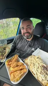 A review of a rump steak kebab and chicken goujons from a local fish and chip shop, filmed by a creator in his car. The video includes close-ups of the food and brief B-roll of the preparation process.