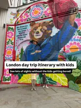 A bright, eye-catching photograph of two children standing in front of a large, colourful Paddington Bear mural in London, used as the cover image for a family-friendly day trip itinerary.