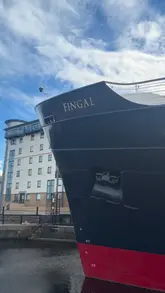 A cinematic tour of the Fingal Hotel, a luxury ship-turned-hotel, focusing on the presentation and variety of their afternoon tea service. The video captures the opulent interior, the waterside setting, and close-ups of the tiered food stand.