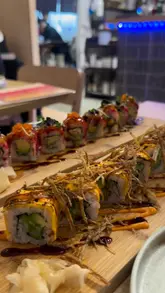 A montage of various sushi dishes, sesame toast, and desserts served at a restaurant. The video focuses entirely on the food presentation with no creator presence or venue atmosphere.