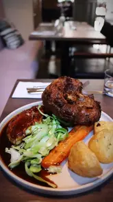 A short, edited montage showcasing a Sunday roast experience at a bistro called Stem. The video includes shots of the exterior, interior, menu, cocktails, oysters, the main roast dinner, and a dessert, featuring the creator enjoying the meal.
