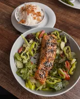Here are a few options for your SEO alt text, keeping under the 125-character limit:

**Option 1 (Descriptive):**
Delicious grilled salmon bowl, chicken schnitzel, and fish fingers served at Cammachmore restaurant, Cammies.

**Option 2 (Brand focused):**
Fresh seafood lunch featuring salmon, schnitzel, and fish fingers at Cammies restaurant in Cammachmore, Aberdeen.

**Option 3 (Concise):**
Gourmet seafood lunch at Cammies restaurant in Cammachmore, featuring a grilled salmon bowl and chicken schnitzel.

**SEO Tip:** If you have an image of the specific dishes, use **Option 1**. If the image is of the restaurant interior/exterior, use **Option 2**.
