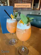 A promotional image featuring two Aperol Sangria cocktails served at a Gusto restaurant, highlighting the venue's participation in Liverpool Cocktail Week.