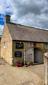 A montage tour of Kirkharle Courtyard in Northumberland, showcasing the cafe, lakeside walk, pottery studio, gift shops, and local produce larder.
