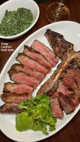 A short, punchy review of MRBL, a new British steakhouse in Leadenhall Market. The video features close-up shots of the menu, including beef croquettes, smoked aubergine, a porterhouse steak, creamed spinach, beef fat chips, and apple crumble, highlighting the quality of the food and the atmosphere of the venue.