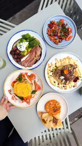 A short, punchy reel showcasing a new brunch menu at Half Cup, featuring close-up shots of various dishes like pancakes, avocado toast, and flatbreads, alongside coffee and matcha drinks.