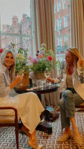 A montage showcasing a floral workshop event at a hotel, featuring shots of floral arrangements, champagne, and a canapé menu.