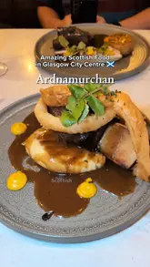 A review of Ardnamurchan in Glasgow, highlighting their focus on sustainable Scottish produce. The video features close-ups of various dishes including scallops with pork belly, a pear and blue cheese salad, venison, beef short rib, and a Scottish cheese board, alongside shots of the restaurant interior and the creator's commentary.