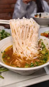 A social group meetup at a Vietnamese restaurant in Hoxton, showcasing various dishes including pho, hot pot, and sharing plates.