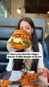 A family-focused review of a visit to a Byron burger restaurant, highlighting the Wagyu Royale Truffle Burger, various sides, and the kid-friendly atmosphere.