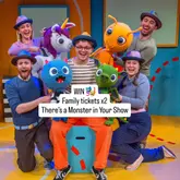 A high-quality promotional image for the family-friendly theatre production 'There's a Monster in Your Show' at the Artsdepot, featuring the cast and puppets in a bright, engaging studio setting.