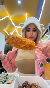 The video features a creator trying various Korean street food items, including corn dogs and kimbap, at a Bunsik location. The editing is fast-paced and focuses on the food, with the creator present throughout.