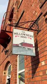 A montage-style video showcasing the interior and exterior of The Millowners Arms in Sheffield. The footage highlights the pub's industrial decor, the outdoor seating area by the water, the games available (pool, darts), and the unique phone box book exchange, accompanied by shots of drinks.