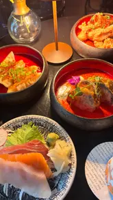 A couple visits Bar Tokyo in Cheltenham, showcasing a variety of cocktails, Japanese small plates like gyoza and sashimi, and the stylish interior of the venue.