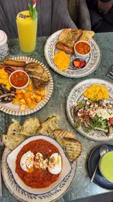 A short, upbeat reel showcasing a brunch visit to Forks & Green, featuring close-ups of various breakfast dishes, hot drinks, and the venue's exterior.