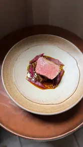 A creator visits Aulis in Soho, London, for a 16-course tasting menu. The video features a fast-paced, energetic review style, highlighting the food preparation at the chef's counter, the wine pairing, and the overall atmosphere of the restaurant.