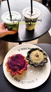 The video features a creator visiting X2 Bakery & Pastry, showcasing a variety of visually striking pastries and drinks. The editing is quick and rhythmic, highlighting the aesthetic appeal of the products and the cafe environment.