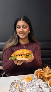 A review-style video featuring a creator showcasing various burgers, loaded fries, and milkshakes from BRIM Burger in Hammersmith. The video includes close-up shots of the food, the creator taking bites, and commentary on the quality of the items.