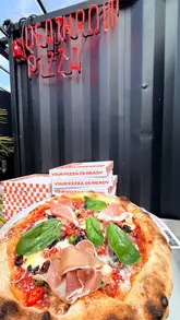 A short, energetic video showcasing a visit to Deathrow Pizza located within Attic Brew Co. The creator highlights the build-your-own pizza process, the menu, the casual atmosphere, and the accompanying drinks, providing a clear overview of the dining experience.