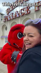 A creator vlogs on Brighton Pier, interacting with the Download Festival mascot to promote the festival's presence at The Great Escape.