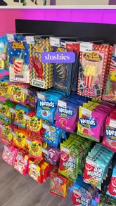 A short, energetic video showcasing the opening of a new sweet shop called 'Melt Melt' in Farnham. The creator gives a quick tour of the store, highlighting various products including milkshakes, slushies, soft serve, sweets, fizzy drinks, chocolate, and fudge.